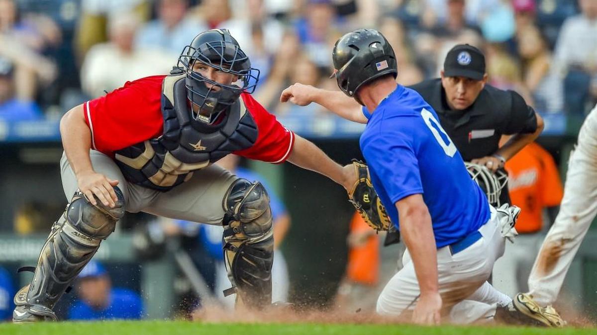 Mill Valley catcher Brady Garrison tags outthird baseman Cameron Pope during the fifth inning of the Ban Johnson Baseball League All-Star Game Thursday at Kauffman Stadium in Kansas City. Garrison played for the B’s, who lost to the J’s 7-0.