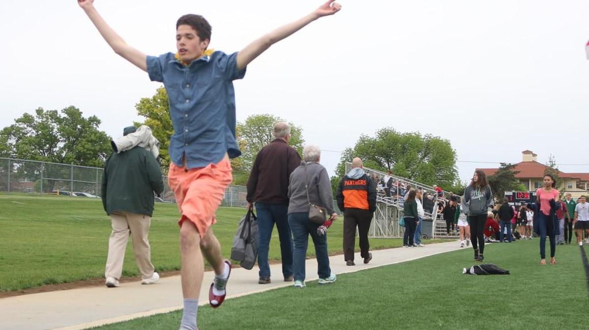 Seventeen-year-old Patrick Wiley of Overland Park finishes his high-heeled mile with a flourish Thursday afternoon at Shawnee Mission South.