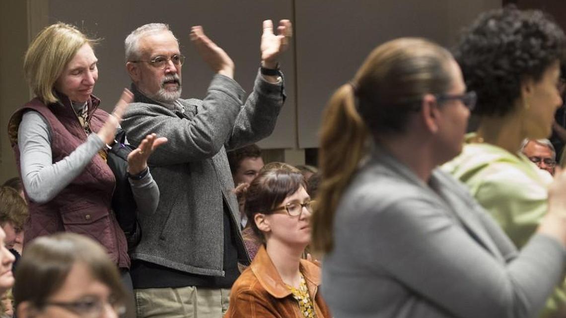 Shawnee Mission School Board members tasked this year with revisiting policies regarding public comments at board meetings said Monday they would be willing to strike down a rule prohibiting complaints about school board members. Pictured: community members clap during a public comment made last November.