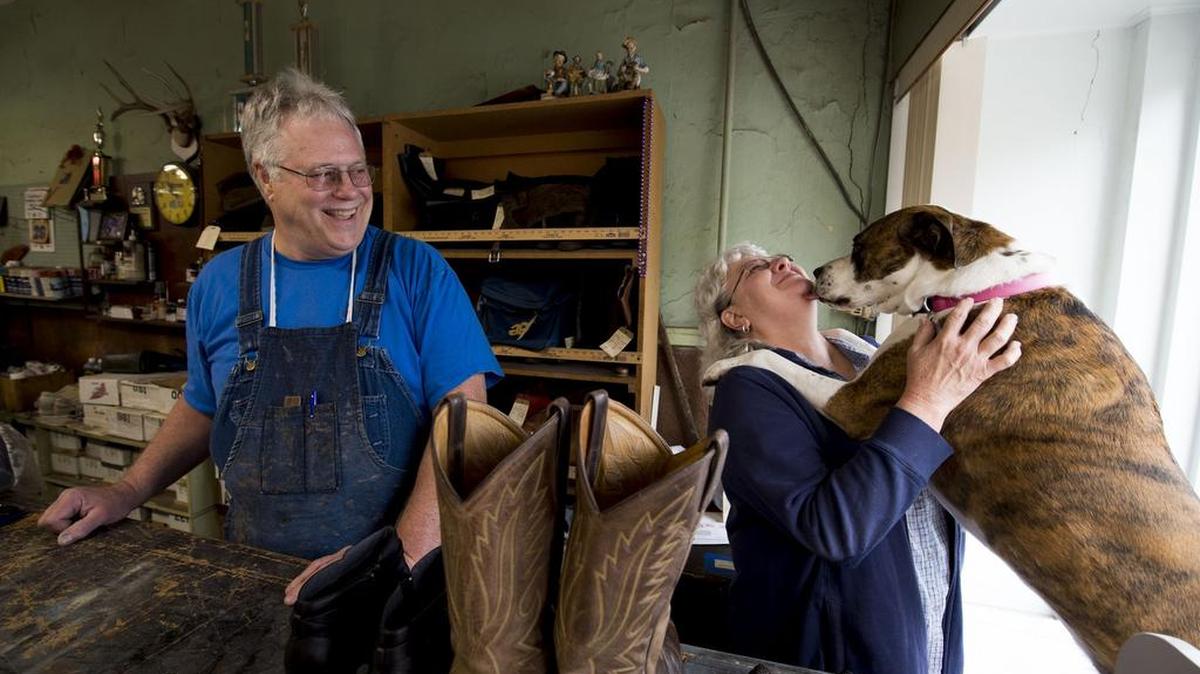 Daryl Mace smiled as his wife Sandy Mace received a hug and kisses from Laila at Mace Shoe Repair in Liberty.