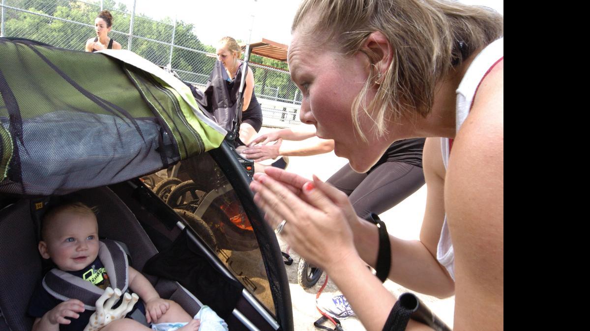 
Tarah Jansen of Lenexa recently played pattycake with her 6-month-old son, Maddox Jansen, while exercising in the Stroller Strides class, part of the Fit4Mom group at Roe Park in Overland Park.
