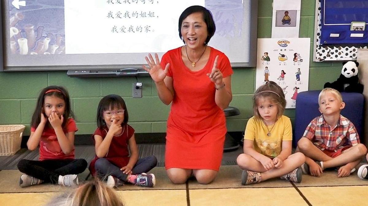 Chinese immersion teacher Claire Pan works with kindergarten students at Wolf Springs Elementary School in Overland Park.