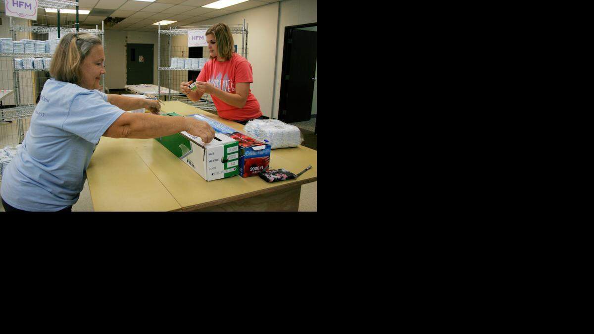 
Volunteers Daren Archer of Raymore and Alexandria Smith of Belton recently helped wrap diapers at Happy Bottoms.
