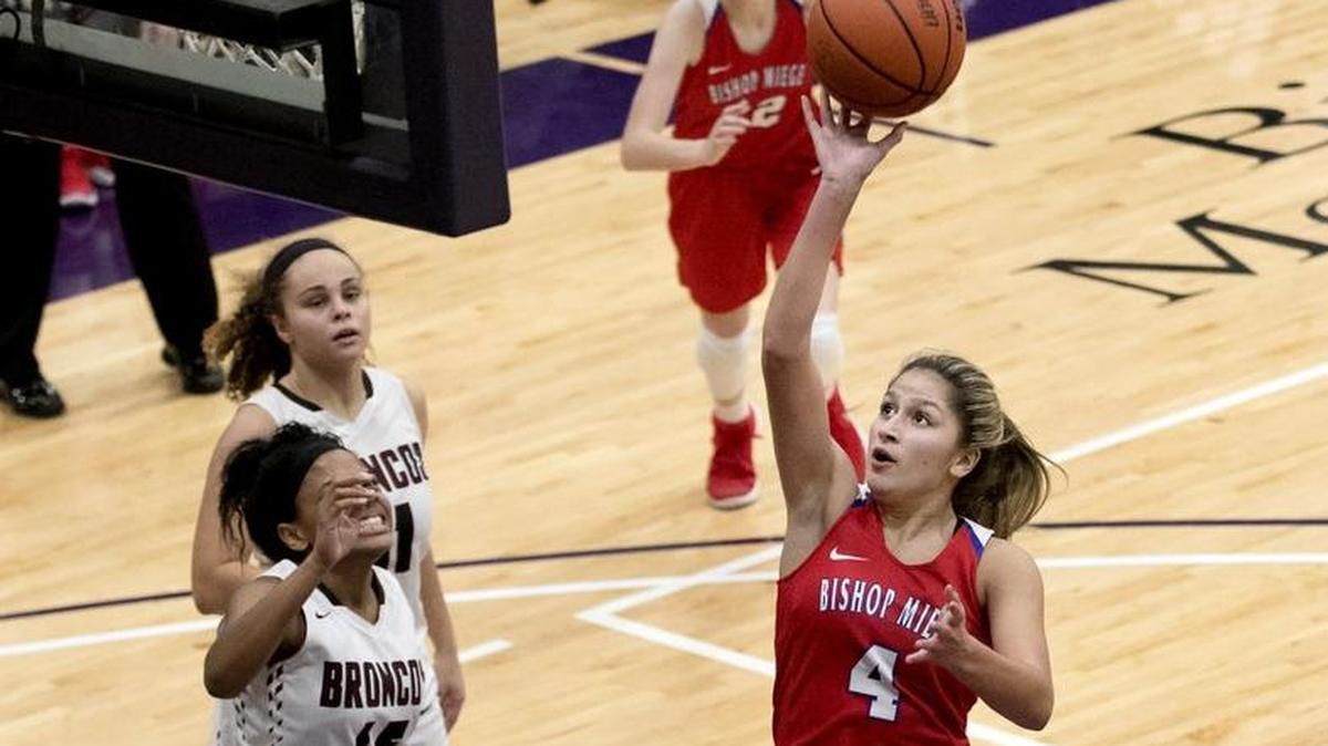 Bishop Miege’s Johnni Gonzalez (right) swooped in for a layup against Lee’s Summit North on Friday, Dec. 15, 2017, during the Cable Dahmer Shootout at Avila University in Kansas City, Mo. Gonzalez scored 14 points as the Stags rolled 71-35.
