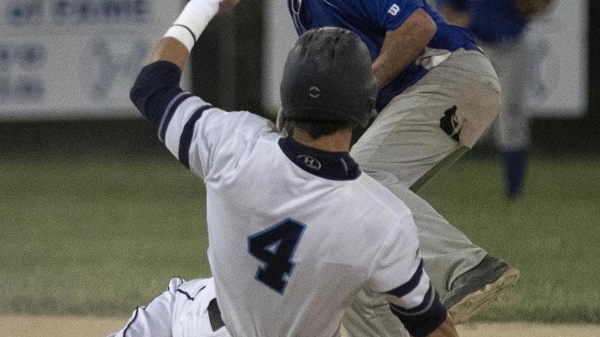 Grant Burns of the BJ Raiders slides into second base in front of Sam Marks of Edelman & Thompson during the Ban Johnson League semifinal playoffs, Wednesdayat the Mid-America Sports Complex in Shawnee. The BJ Raiders swept the best-of-three series and advanced to the finals.