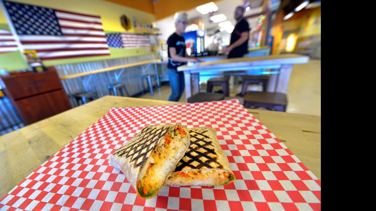 
The Wow! Kung Pao wrap sandwich at Longboards Wraps & Bowls is a grilled wrap that mixes chicken with peanuts, pepperjack, vegetables, rice, Sriracha and Longboards’ spicy Chinese sauce.
