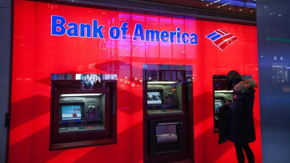 A customer uses an automatic teller machine (ATM) inside a Bank of America Corp. branch in New York. Bank of America recently began charging fees to account holders with low balances.
