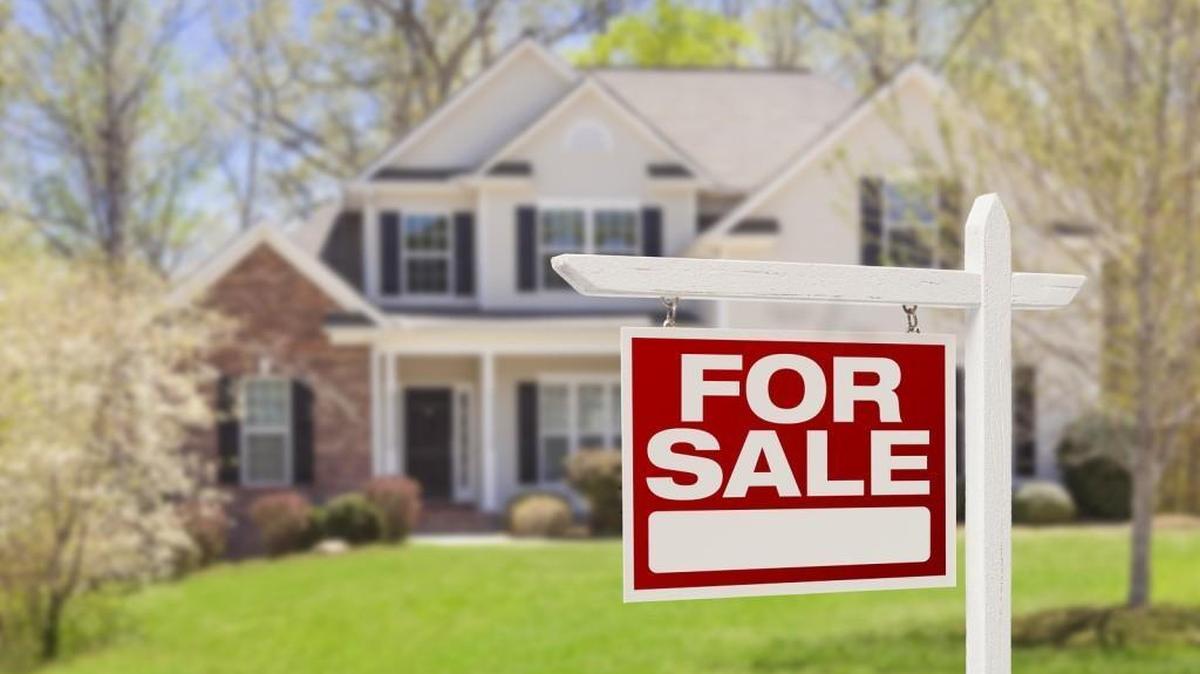 Home For Sale Real Estate Sign and Beautiful New House.