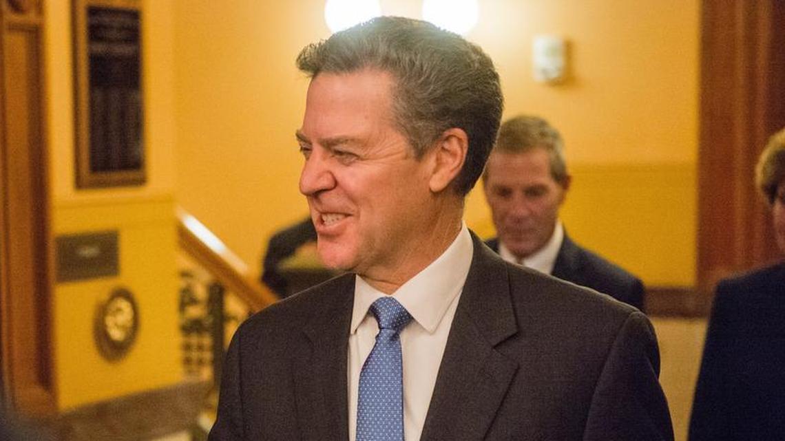 Kansas Governor Sam Brownback walks into the House chamber Tuesday, Jan. 9, to deliver his last State of the State speech.