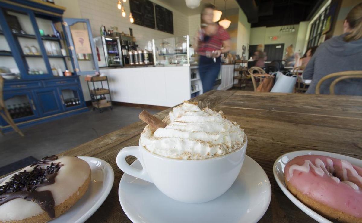 A pumpkin spice latte can be paired with a chocolate caramel or strawberry doughnut at Pour Coffeehouse, 11120 S. Lone Elm Road, Olathe.