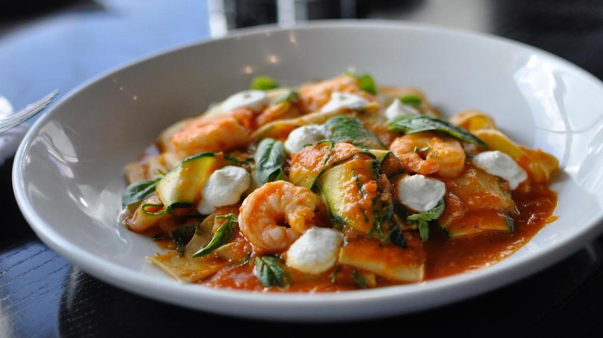 The pappardelle at Grand Street Cafe consists of thick ribbons of pasta with zucchini in a citrus-laced tomato sauce. It is topped with ricotta, basil and shrimp.
