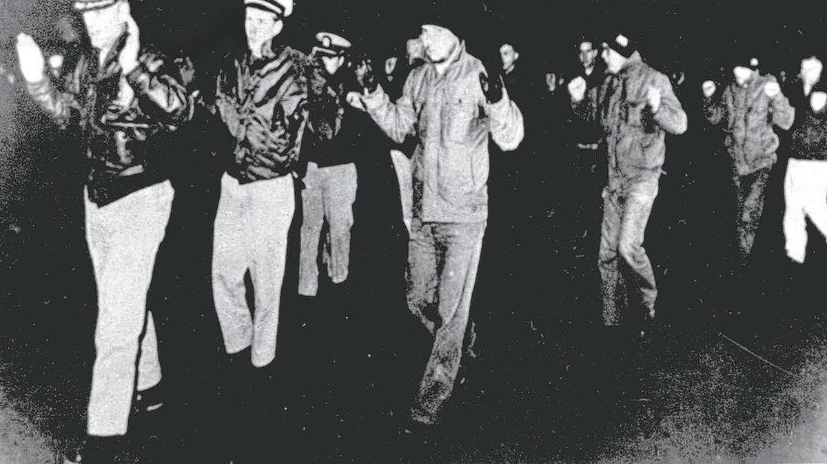 Crew members of the U.S. Navy intelligence ship USS Pueblo were led into captivity after the vessel was seized by North Korean patrol boats in the Sea of Japan in January 1968.