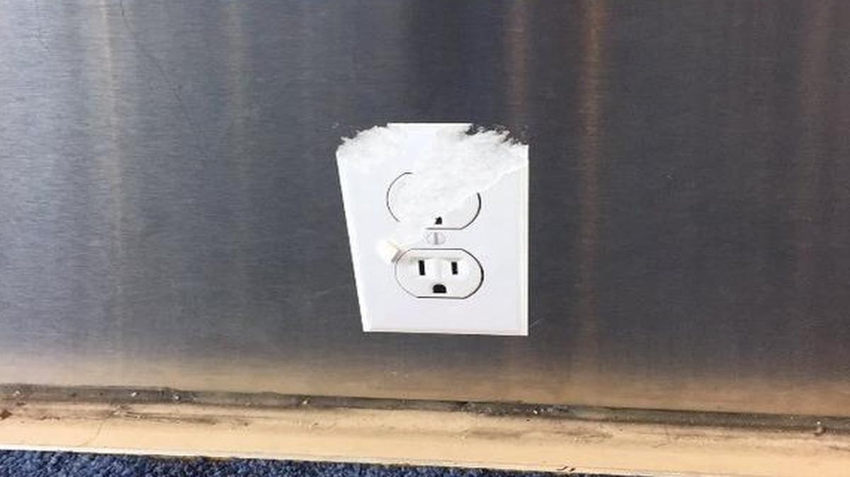 Eureka! An unused outlet at the airport? No, it’s a sticker, somebody’s cruel trick on fellow travelers.