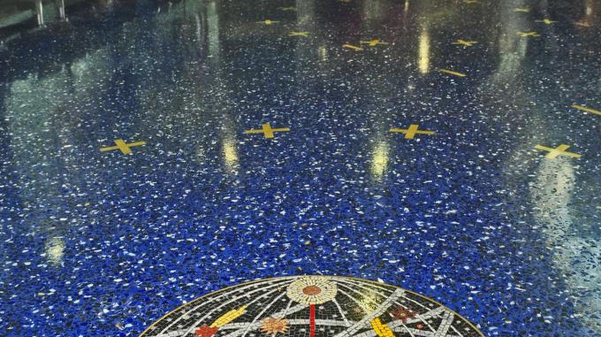 The blue Terrazzo floors at KCI are punctuated with random mosaics.