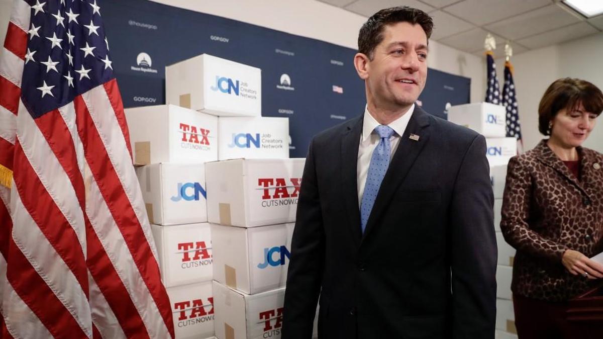 Speaker of the House Paul Ryan, followed at right by Rep. Cathy McMorris Rodgers walks past boxes of petitions supporting the Republican tax reform bill that is set for a vote later this week as he arrives for a news conference on Capitol Hill in Washington on Nov. 14.