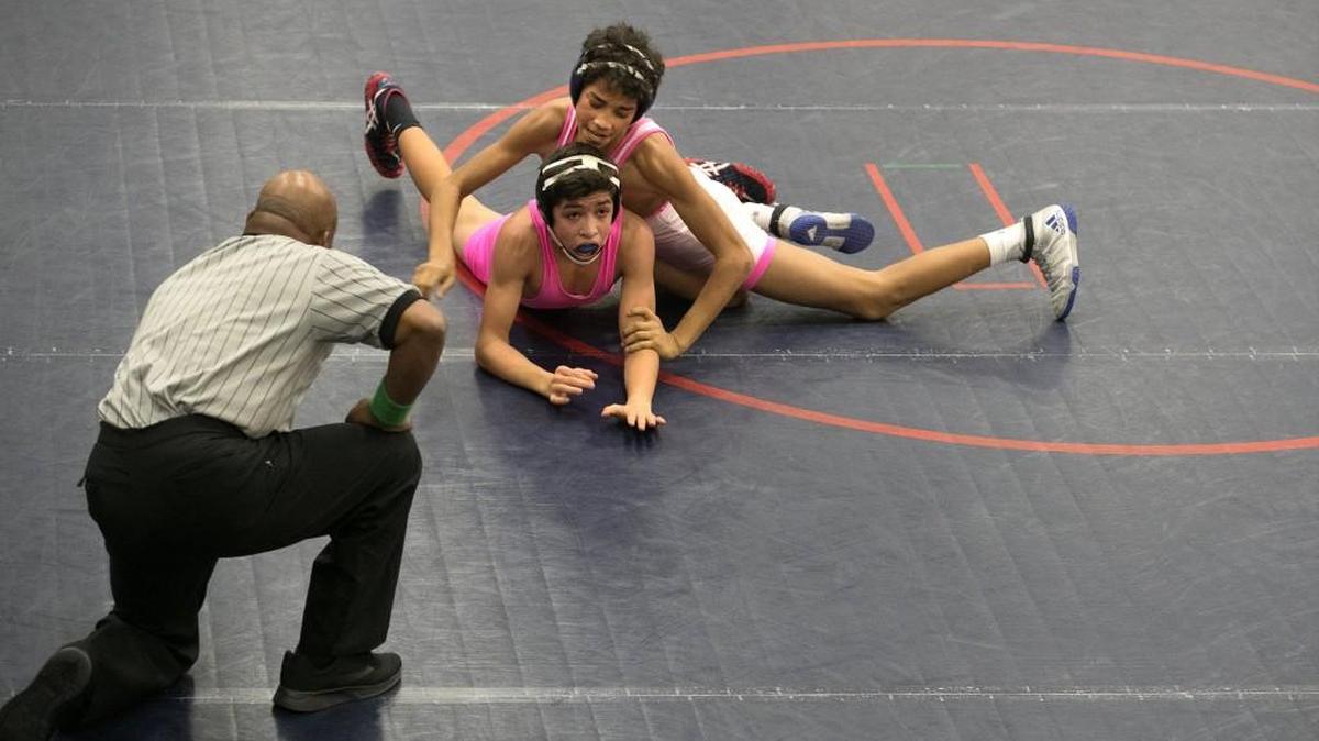 Olathe North’s Joe Triscornia (bottom) tried to escape St. Thomas Aquinas’ Malachi Vann during the 106-pound championship dual Saturday, Jan. 27, 2018, at the Olathe North Wrestling for a Cure Tournament.