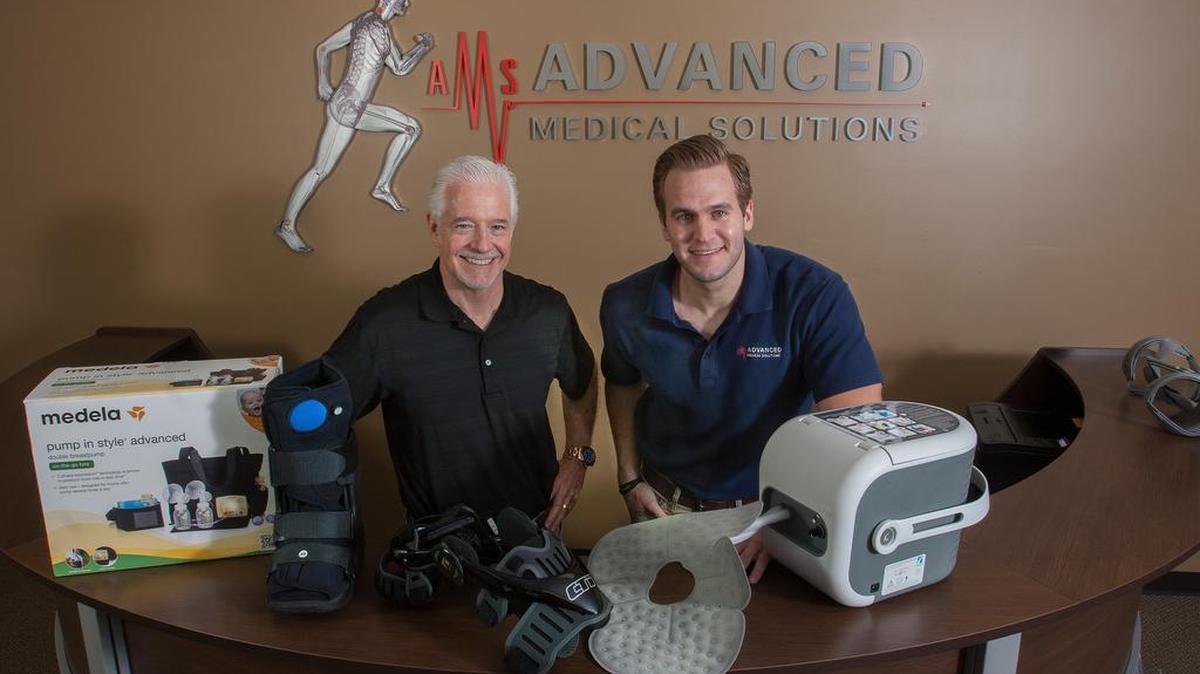 
Co-owner Marty Metz (left) and Evan McFarlane, operations director of Advanced Medical Solutions in Lenexa, display medical products including a breast pump (from left), air-inflated walking boot, functional knee brace and cold therapy machine.
