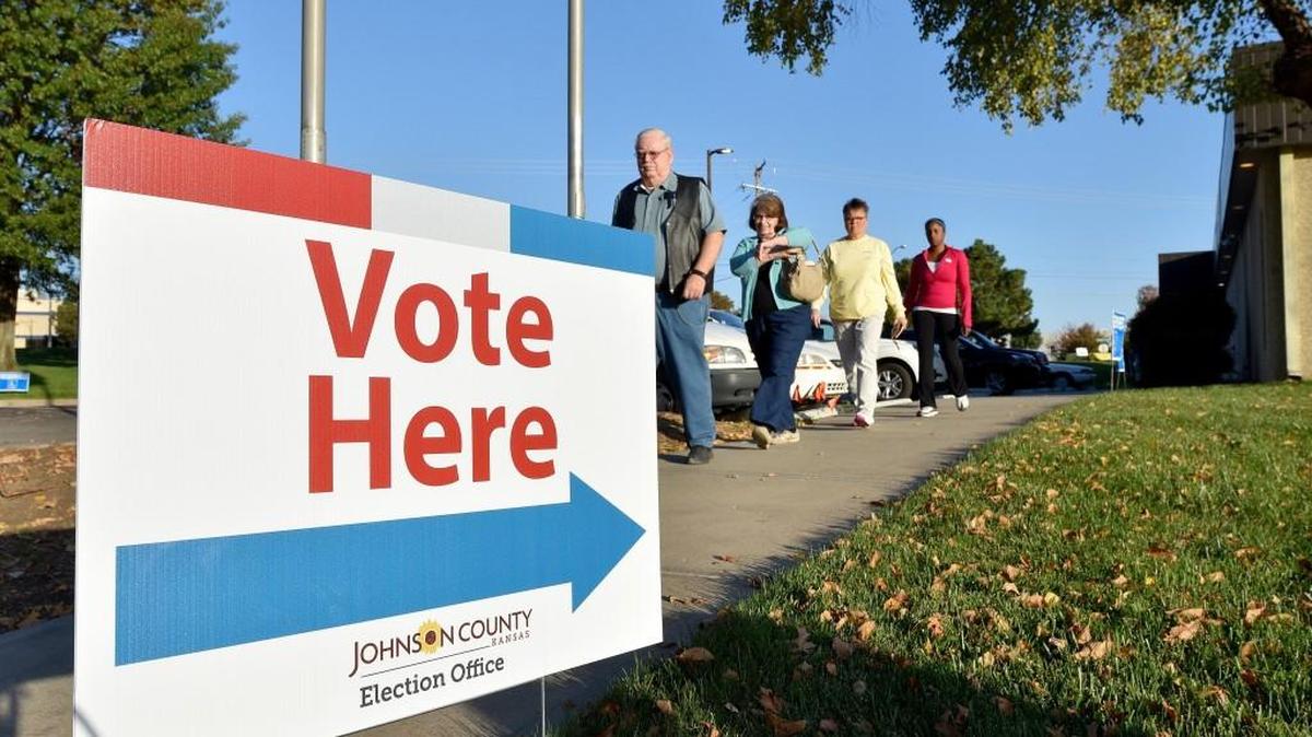 Voters head back to their cars during the first day of early voting at the Johnson County Election office, 2101 E. Kansas City Road, Olathe, Kan., on Oct. 24, 2016.