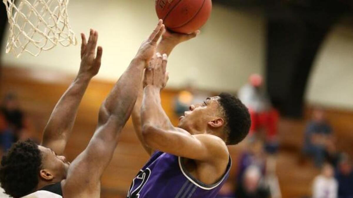 Blue Valley Northwest’s Joe Pleasant (right) shot over Grandview’s Cartez Crook-Jones on Saturday, Jan. 13, 2018, during the 810 Varsity Showcase at Lee’s Summit. Pleasant scored 12 points, but the Huskies lost 58-53.