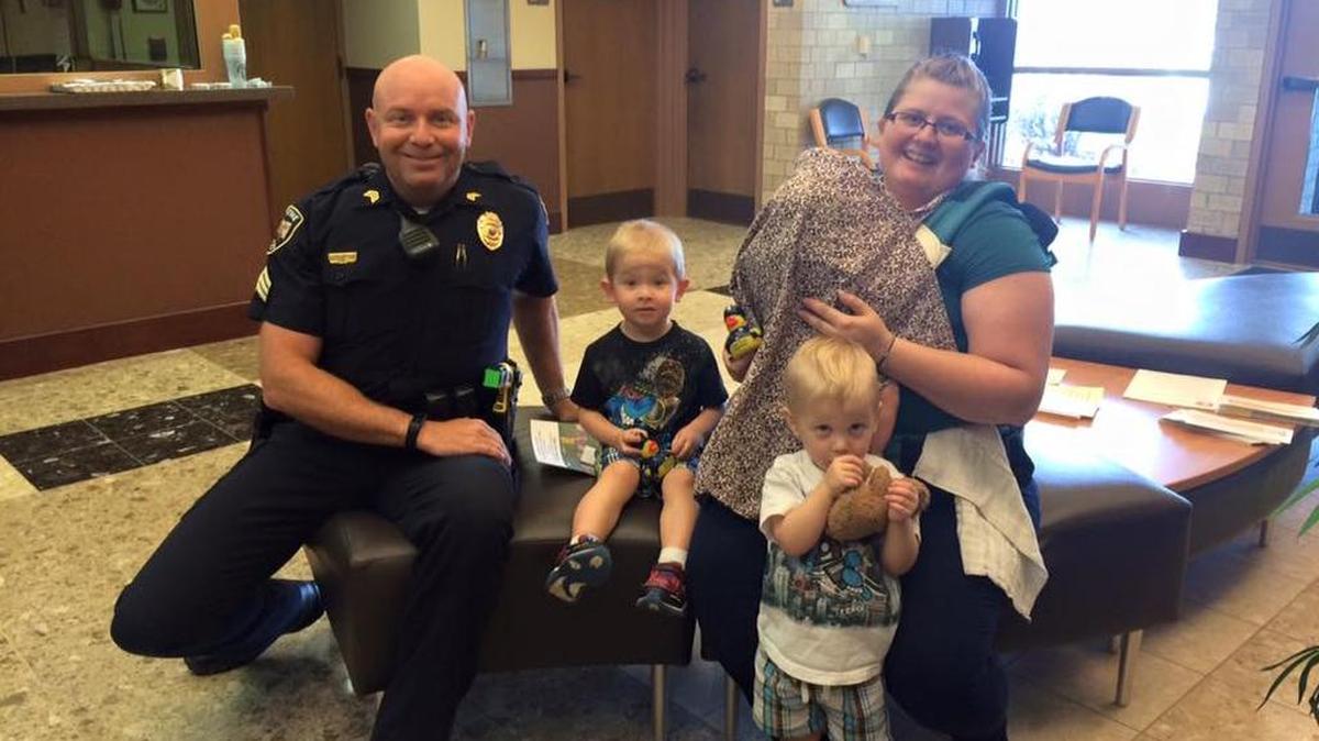 
The people in the photo are Sgt. Bryan Hill (Olathe PIO) and Mandi VanGordan, her 4-month-old daughter, Jocelyn, and her twin 2-year-old sons Joseph (white shirt) and Jeffrey (black shirt). She brought her sons to the police department to deliver homemade chocolate chip cookies to the officers.
