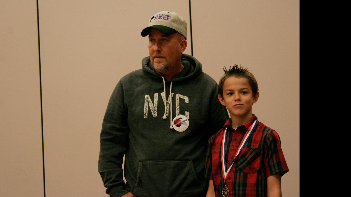 
Ten-year-old Eli Kehl received recognition for calling the 911 emergency center to help his stepdad, Dan Nevius (left).
