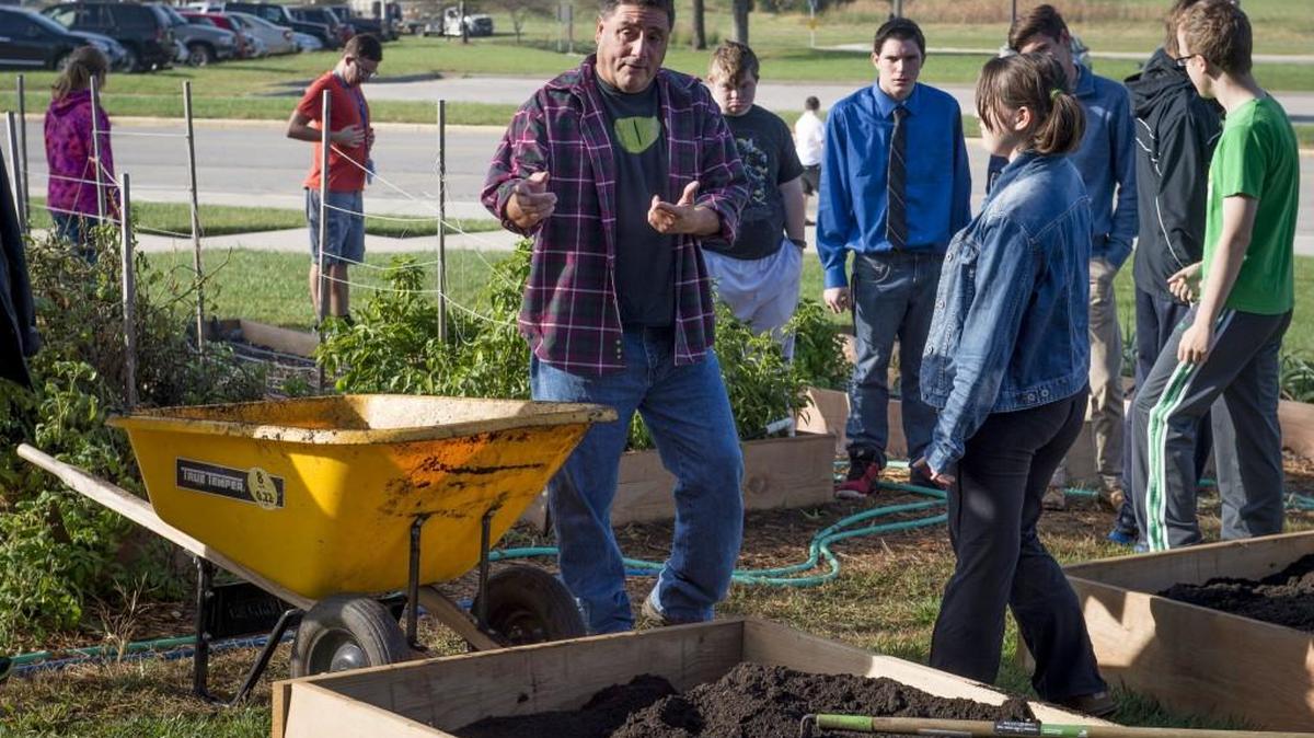 Tim Oberhelman recently showed a group of horticulture and special education students newly made elevated gardens at Olathe Northwest High School.