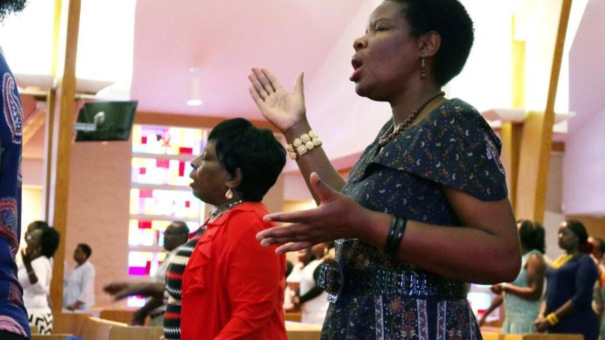 Rosemary Njoroge sings and moves to the music during a Sunday service at Neema Community Church.
