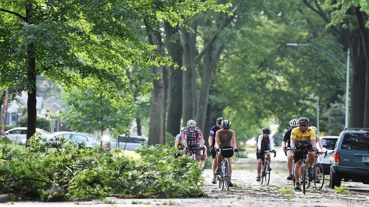 After heavy storms with strong winds moved through the area Saturday night, the storm damage was apparent Sunday in Prairie Village where bicyclists rode past tree debris strewn along 69th Street, just west of Mission Road.