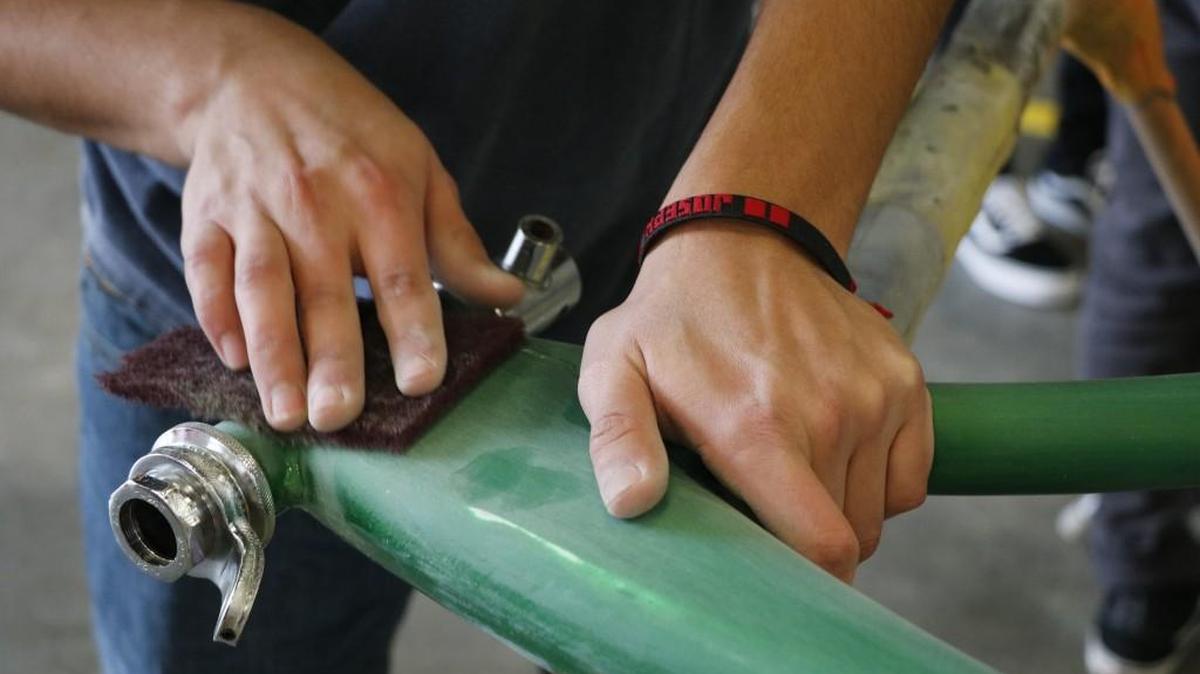 Joseph Ibarra, 17, scuffed the frame of his custom lowrider bicycle in preparation for the painting process Tuesday, Feb. 27, 2018, during a meeting of the Olathe North Hispanic Leadership Council’s Lowrider Club at the Olathe Public School’s Advanced Technical Center.