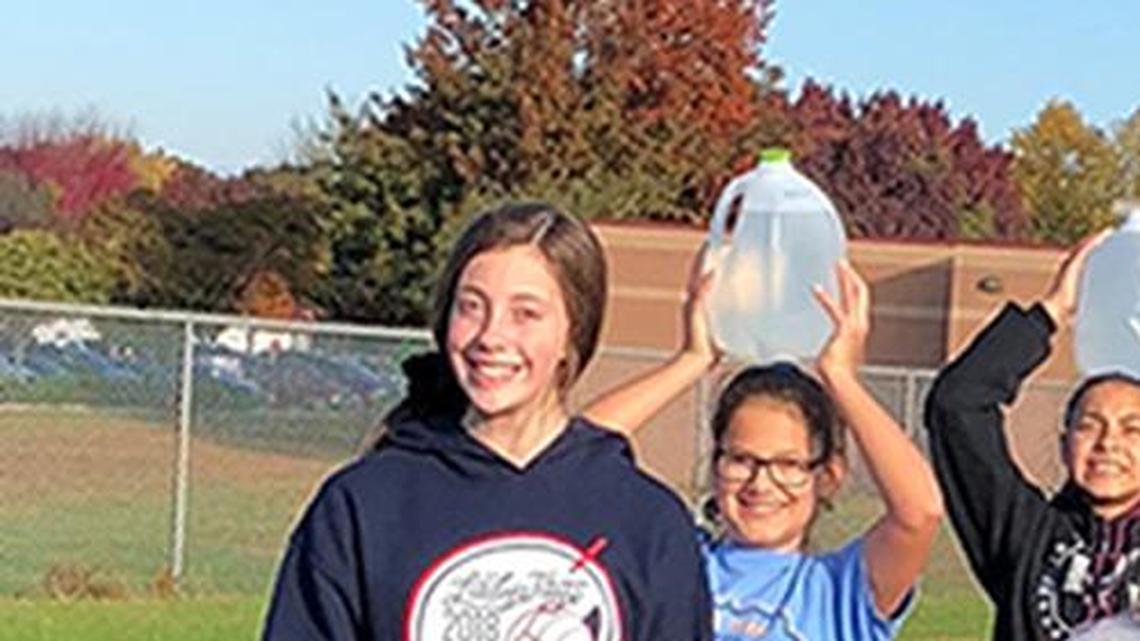 Seventh-grade girls from Frontier Trail Middle School took a quick break during a walk-a-thon to raise money for water wells and sanitation in South Sudan