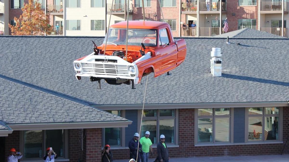 
Workers with A.L. Huber General Contractor helped as a crane operator placed the truck into the courtyard of Cedar Lake Village.
