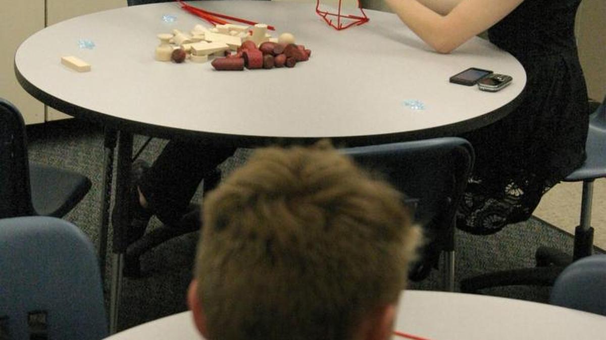 Hunter LaFevers (upper right) and intern Johnathan Raines demonstrated team building exersizes while a youth followed along at the juvenile evening reporting center, Millcreek Center, 150 S. Water St., Olathe. The Evening Reporting Center is an after-school program for youth offenders who violate probation. The project is aimed at reducing youth incarceration.