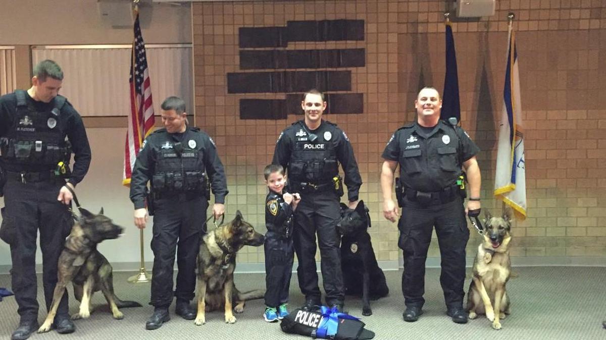 Grant gets a kiss from Axel as the Olathe police department recognizes him for his support.