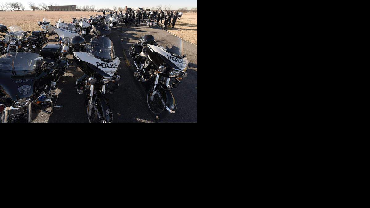 Motorcycle officers from the surrounding metropolitan area waited Tuesday to lead a funeral procession for Olathe Police Office Michael Kern.