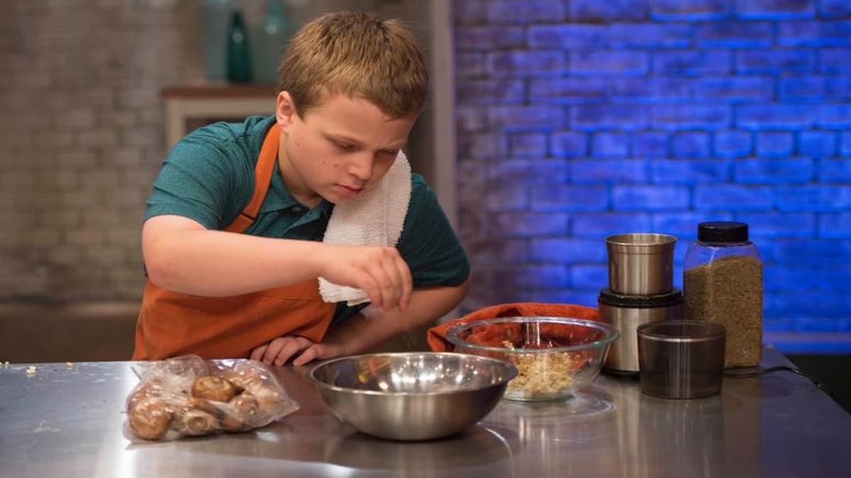 
Contestant Zach Hofen races to finish a dish in the “Fusion Impossible” challenge as seen on Food Network’s “Rachael Ray’s Kids Cook
‐Off.”
