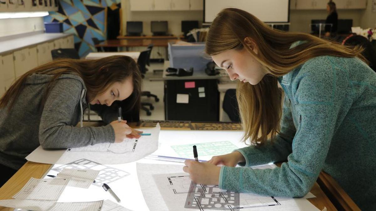 During a recent Fashion, Apparel and Interior Design class, Olathe South junior Hannah Richards, left, and sophomore Anna Desmarteau each designed a single room as part of a collaborative project to design a complete house.