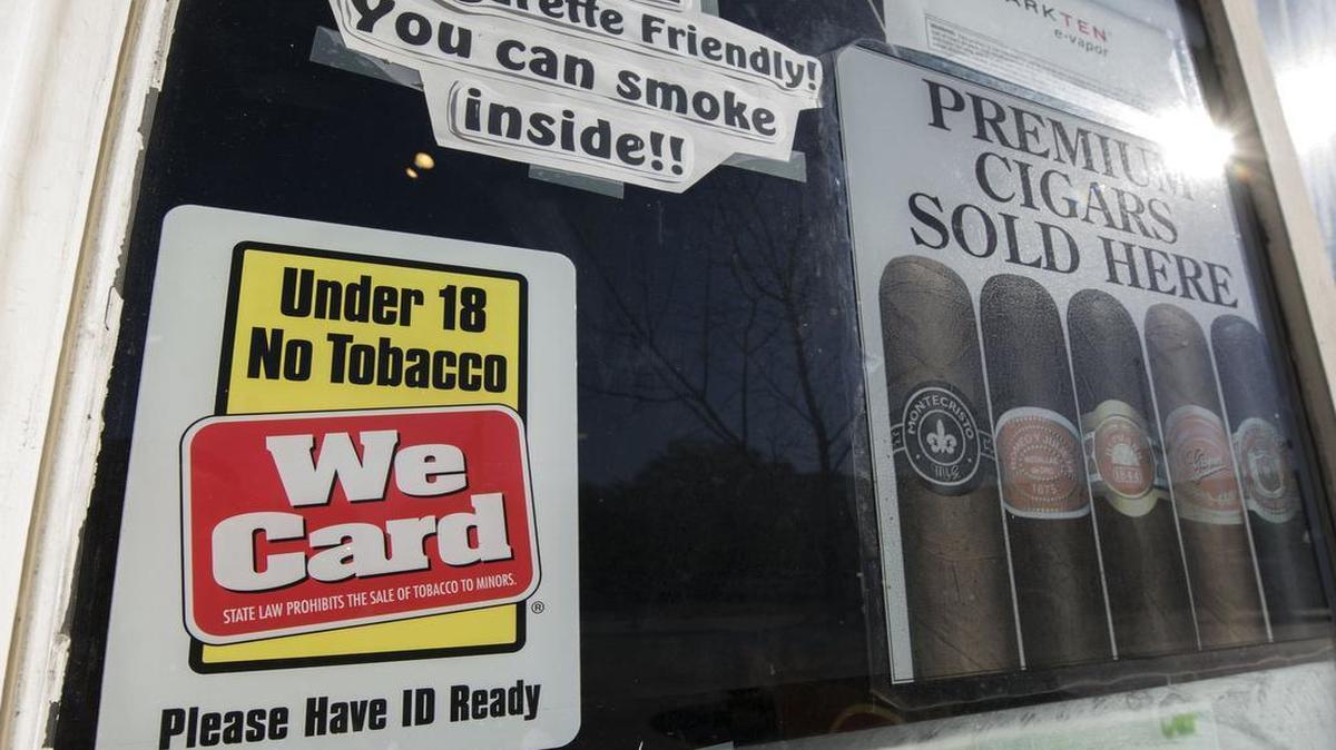 A sign alerting patrons that they must be 18 years old to buy tobacco is posted in the window at Main Street Tobacco & Gifts, 4307 Main Street, on November 19, 2015 in Kansas City, Missouri. The Kansas City City Council to vote on raising the minimum age to buy cigarettes and other tobacco products from 18 to 21.