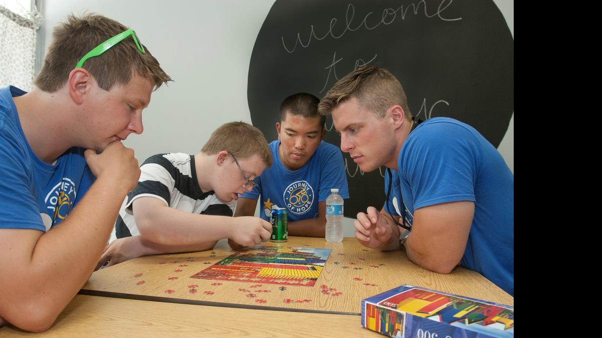
Members of Pi Kappa Phi fraternity stopped this week at Inclusion Connections, a nonprofit that works with youth with developmental disabilities. The fraternity members are part of the 28th annual bicycle ride from Seattle, Wash., to Washington, D.C. Matt Horn, a client of Inclusion Connections (second from left), worked with Matt Bryant (from left) Francis Ahrens and Josh Mensinger on a jigsaw puzzle.


