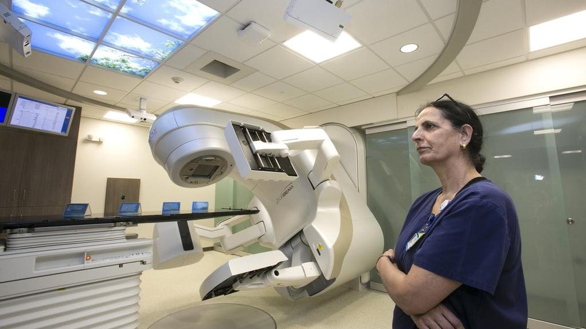 Romi Nijjar, lead radiation therapist, explained the Linear Accelerator, a radiation technology, to visitors to the new Olathe Heath Cancer Center on Tuesday, Feb. 27, 2018, during a dedication and open house for the new center.