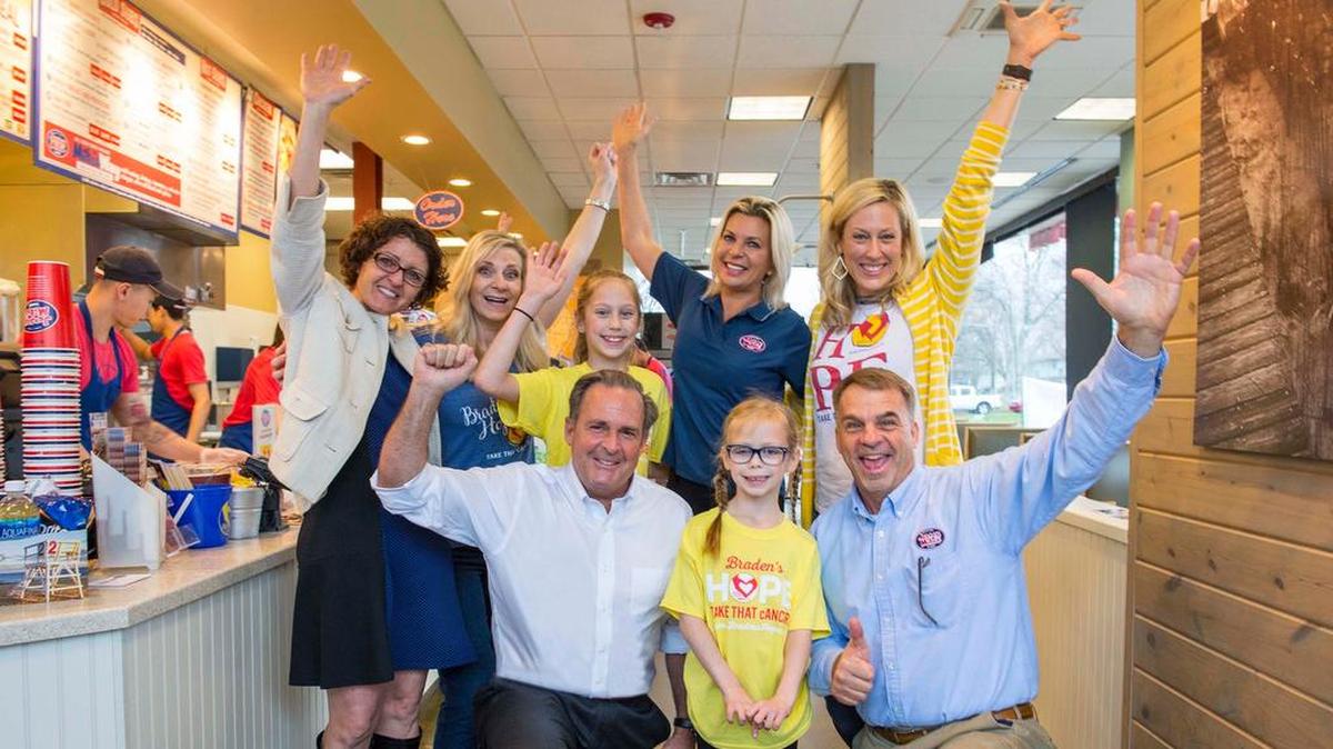 Jersey Mike’s owner Peter Cancro (kneeling, left) celebrated the company’s annual Day of Giving with Callyn Stanley (kneeling, center) and Area Director Mike Spiegel on Wednesday at the franchise location in Olathe. They were joined by (back row, from left) Shelia Montgomery, Deliece Hofen, Taylor Stanley, Tatiana Voevodina Cancro, and Kim Stanley.