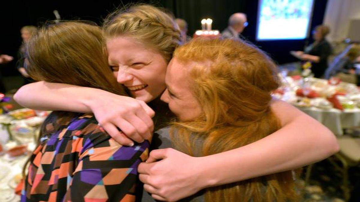 
After speaking at the Promise of Hope luncheon, Makaila Gay (center), 17, hugged her friends Kristin Wyatt (left) and Jillian Lewis. 

 
