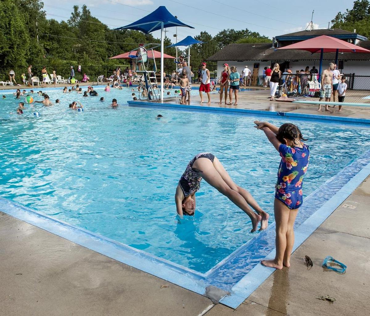 Julie Morris demostrated diving Saturday for her 5-year-old daughter, Miranda Morris, both of Overland Park, at the Roe Pool. Roe Pool is one of several at least three pools in the Johnson County city that have since closed.  