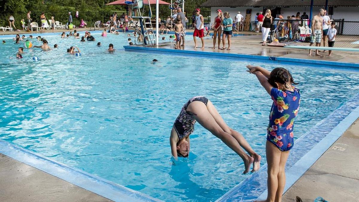 
Julie Morris demostrated diving Saturday for her 5-year-old daughter, Miranda Morris, both of Overland Park, at the Roe Pool.


