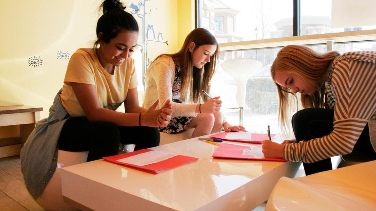 Eighth-graders Hiya Nouman, Paige Faust and Olivia Doolittle, all 13, recently brainstormed about how to promote a frozen yogurt business, like Banana Island in Leawood.