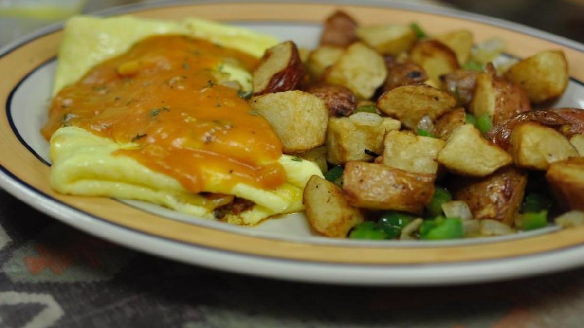 Santa Fe Cafe’s Bandito omelet is stuffed with chorizo, ham, green pepper, onion and cheese. It’s topped with creamy cilantro tomato sauce. It comes with hash browns, but for 50 cents more, customers can get Santa Fe Trail Taters, shown here.
