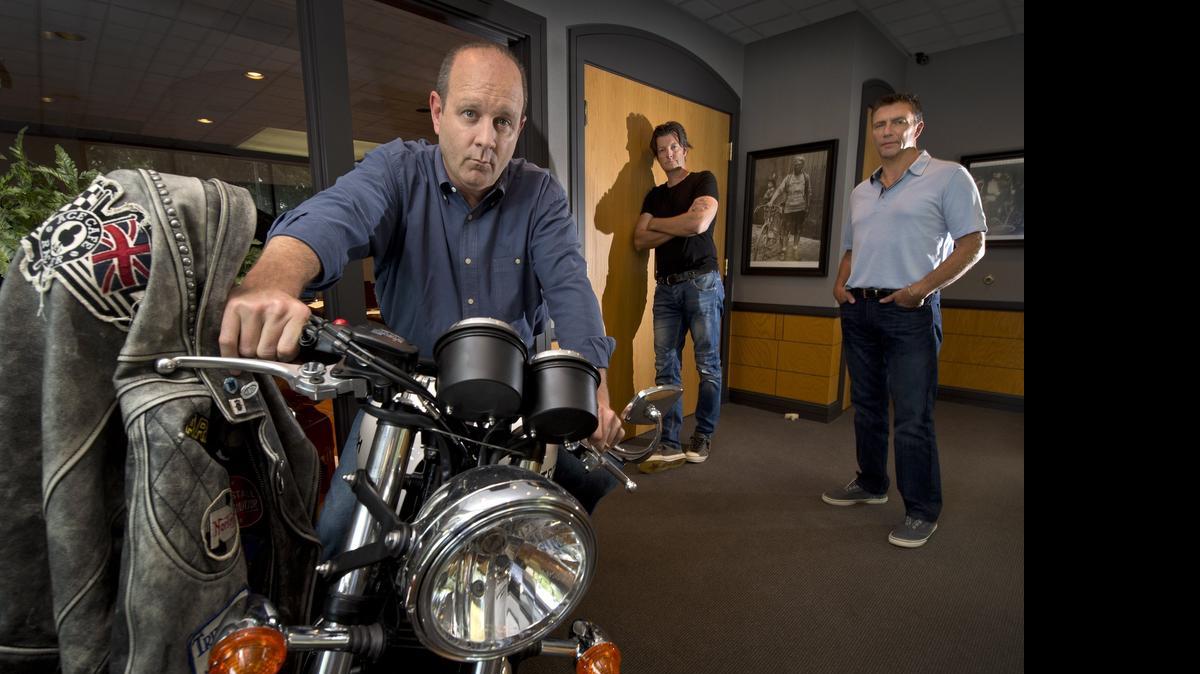 
A Triumph Thruxton ACE Special Edition is on display in the offices of ACE Cafe North America in Overland Park. The company is led by (from left) CEO Mark McKee, chief marketing officer Steve Glum and chief financial officer Eric Forward.
