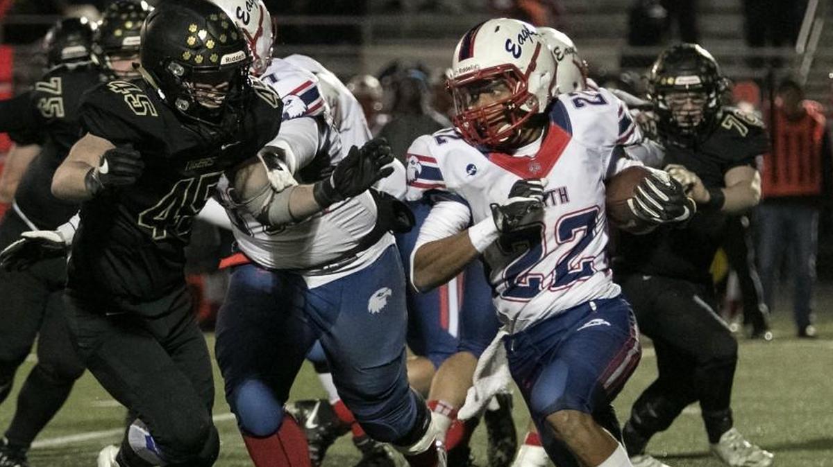 Olathe North’s Daymonn Sanchez, right, looks to turn the corner.