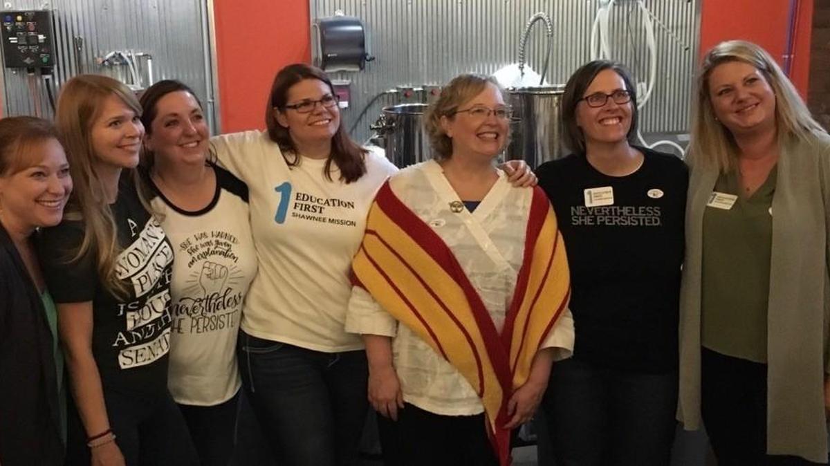 Shawnee Mission West board candidate Laura Guy, pictured in yellow and red, poses with members of Education First Shawnee Mission. Guy defeated incumbent Craig Denny with 60 percent of the vote on Tuesday night.