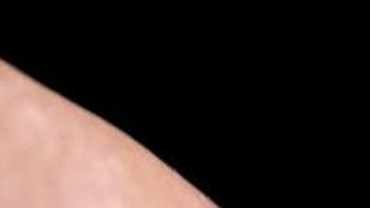 Apple Iphone 6 screen with social media applications of Facebook, Instagram, Twitter, Linkedin, Tango, Perisfind, Google Plus and Skype while a male finger is about to touch on Facebook app.