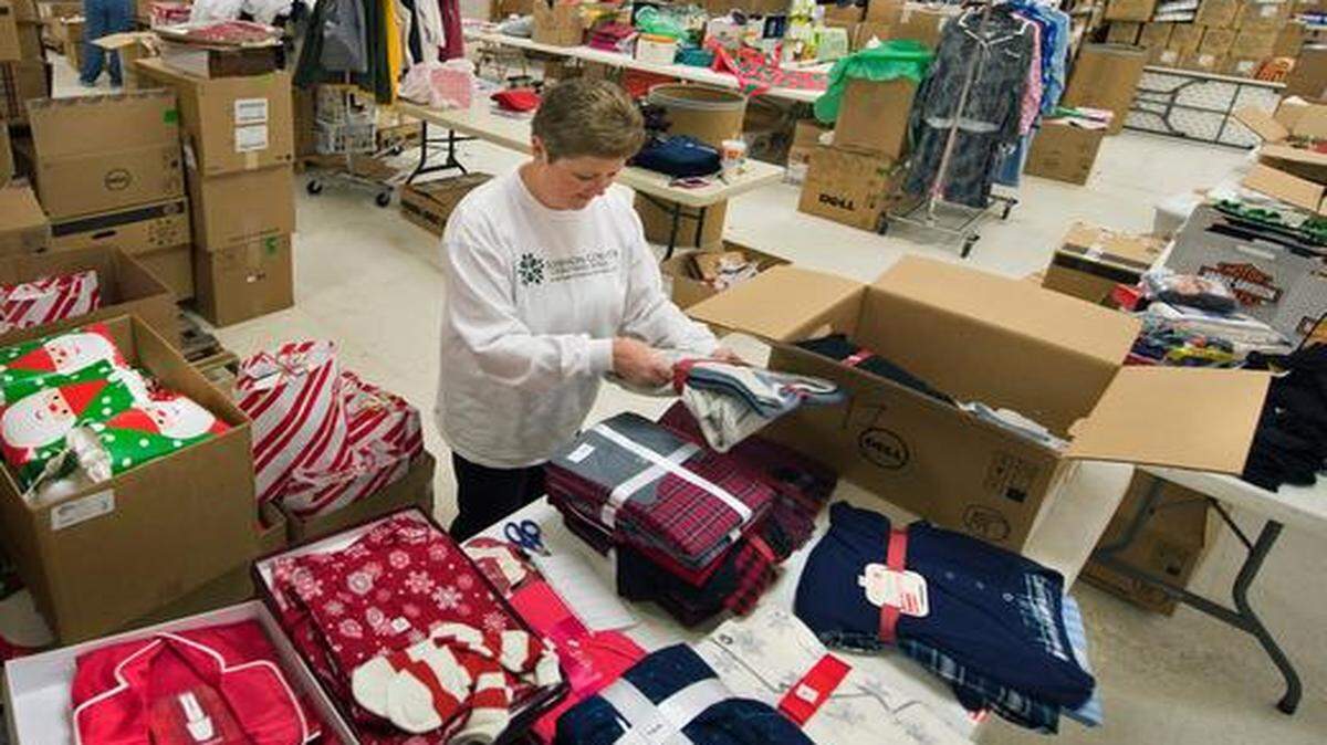 Volunteer Shelly Kelm of Overland Park sorted pajamas recently while setting up the adult gift section at the Johnson County Christmas Bureau in Olathe. The Christmas Bureau provides holiday assistance, including groceries, clothing, personal care items and gifts, to pre-qualified Johnson County families in need. <137>The nine-day Holiday Shop, which last year helped over 3,300 families, is in dire need of children's coats. Currently they are seeking donations of about 3,000 new or gently used children's coats. Location of donation barrels can be found at the JCCB website at www.jccb.org or donations can be dropped off at the Holiday Shop, located in a store front on the north east corner at the Great Mall of the Great Plains in Olathe.<137>
